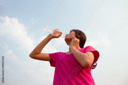 Asian lady drink water after running sport