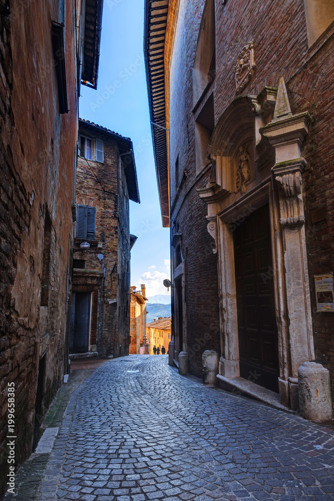 Narrow alley in the medieval town Urbino, Marche, Italy.