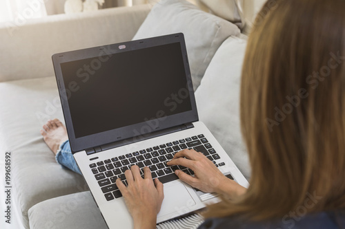 woman using a laptop searching web, browsing information