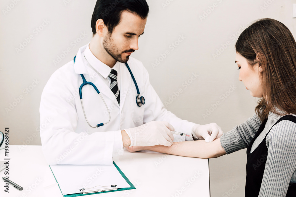 Doctor in protective gloves giving a female patient injection in hospital.healthcare and medicine Doctor in protective gloves giving a female patient injection in hospital.healthcare and medicine