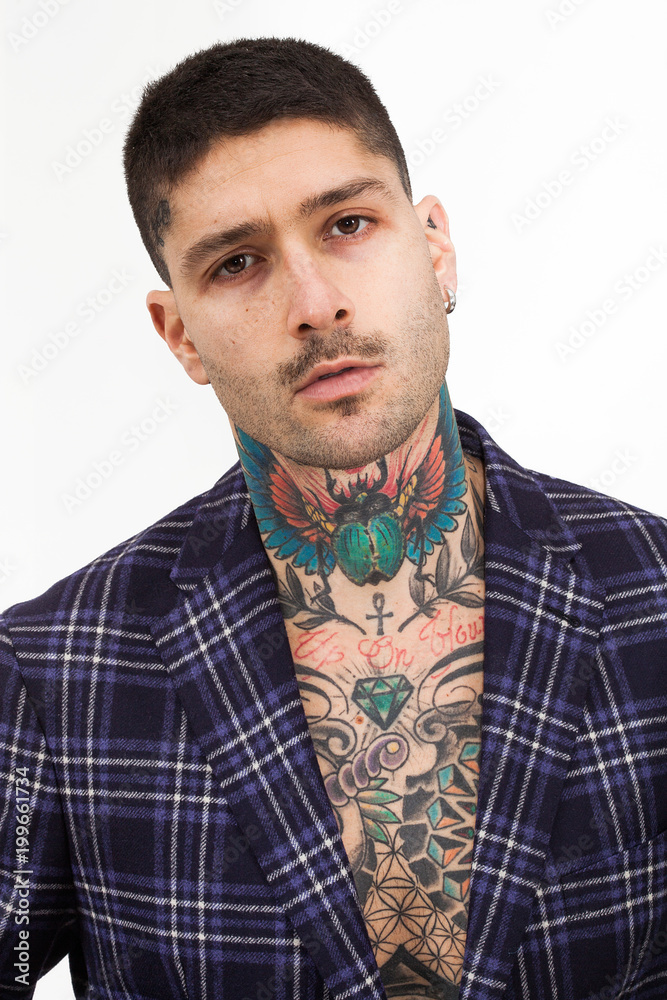 Fototapeta premium Handsome and confident tattooed man portrait wearing tartan jacket