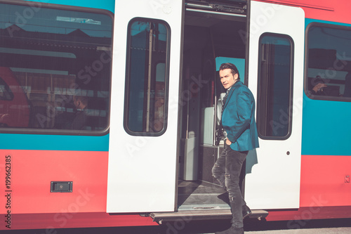 Businessman getting in train and commuting to work.