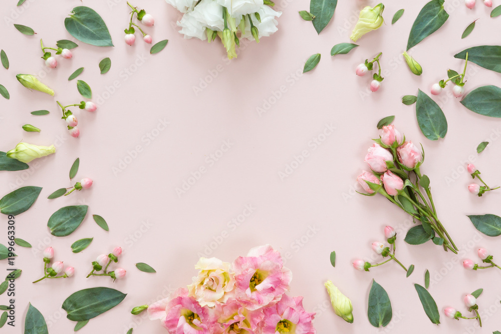Top view of flower pattern of pink and beige buds, green leaves, branches and berries on pink background with copy space. Flat lay, top view. Flowers texture