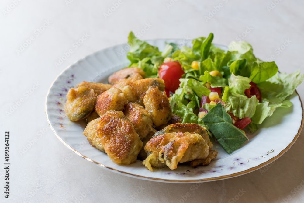 Fried Crispy Mussels Served with Salad. Fried Crispy Mussels Served with Salad.