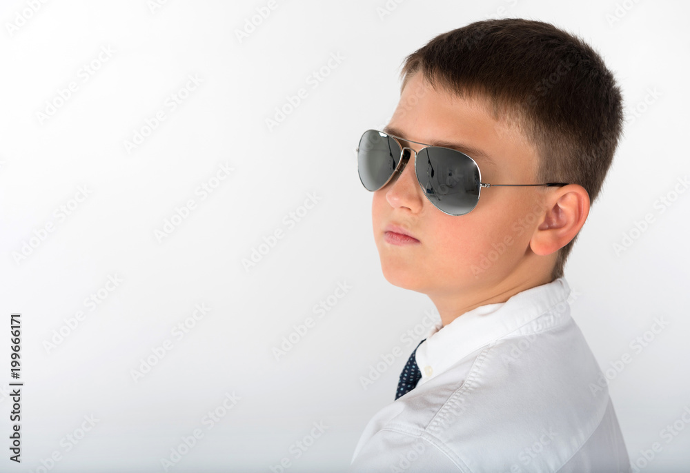 A portrait of a young child, businessman wearing glasses in the studio against the white isolated background. A portrait of a young child, businessman wearing glasses in the studio against the white isolated background.