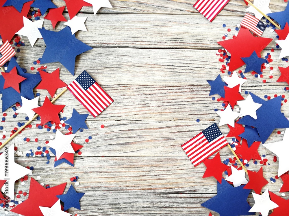 Obraz premium American independence Day, celebration, patriotism and holidays concept - flags and stars on the 4th of July party on top on wooden background