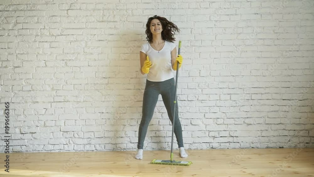 Woman cleaning parquet floors in the living room. Close-up. Woman cleaning parquet floors in the living room. Close-up.