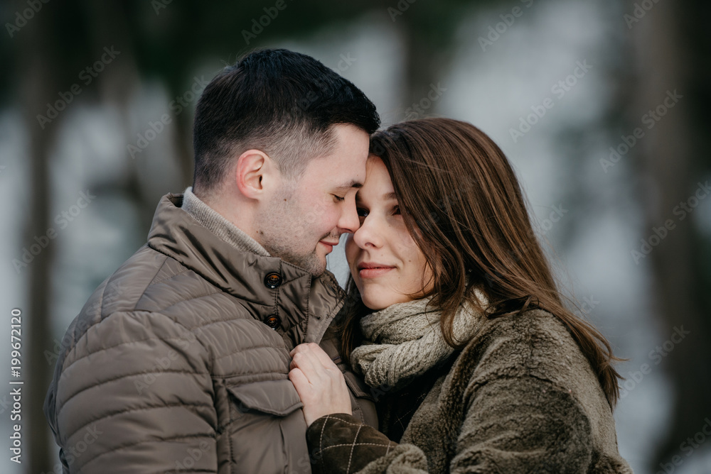 Young man with his gorgeous girlfriend smiling and embrace. Close portrait of two lovers. Young man with his gorgeous girlfriend smiling and embrace. Close portrait of two lovers.