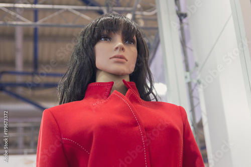 Realistic female mannequin in a red coat © DmyTo