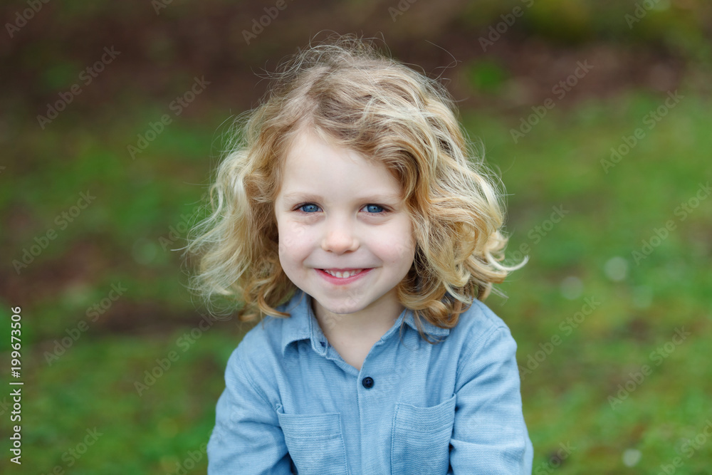 Happy child with long blond hair enjoying the nature Happy child with long blond hair enjoying the nature
