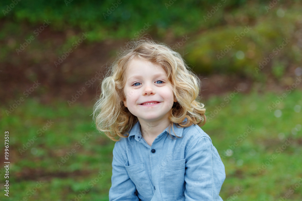 Happy child with long blond hair enjoying the nature Happy child with long blond hair enjoying the nature