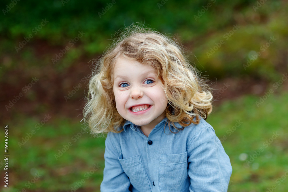 Happy child with long blond hair enjoying the nature Happy child with long blond hair enjoying the nature