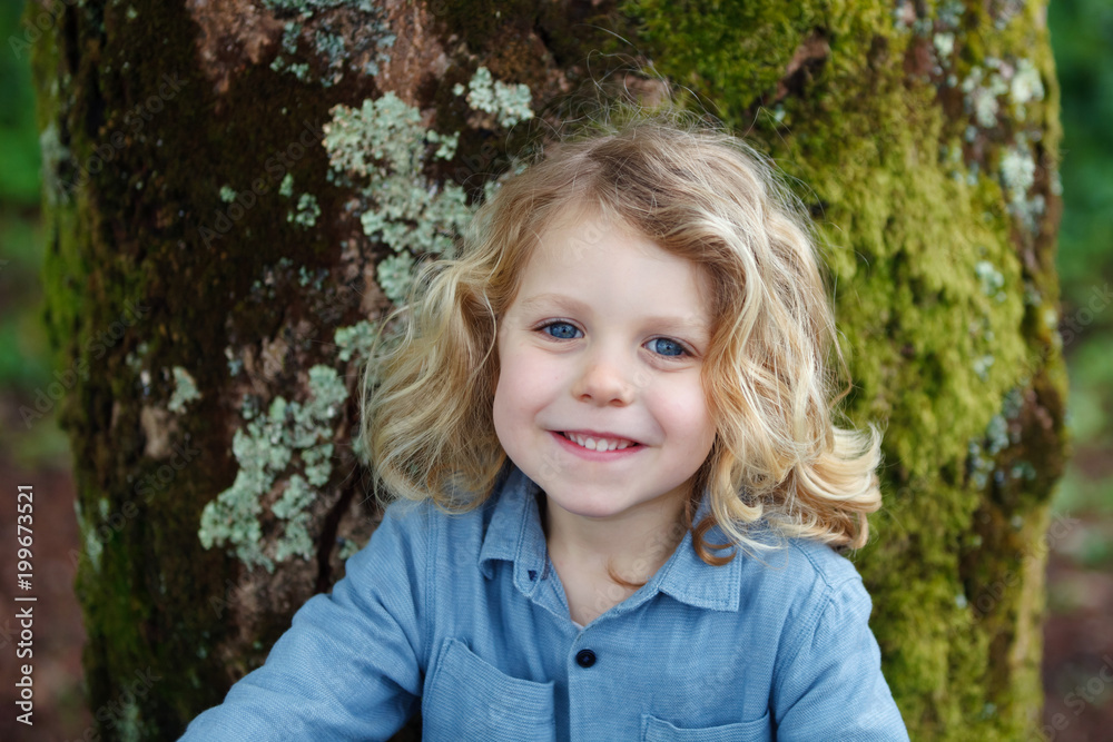 Happy child with long blond hair enjoying the nature Happy child with long blond hair enjoying the nature