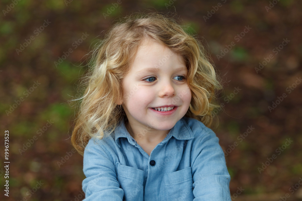 Happy child with long blond hair enjoying the nature Happy child with long blond hair enjoying the nature