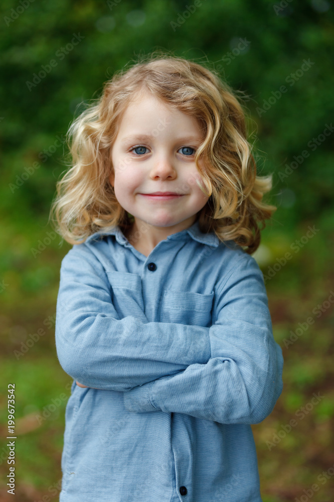 Happy child with long blond hair enjoying the nature Happy child with long blond hair enjoying the nature