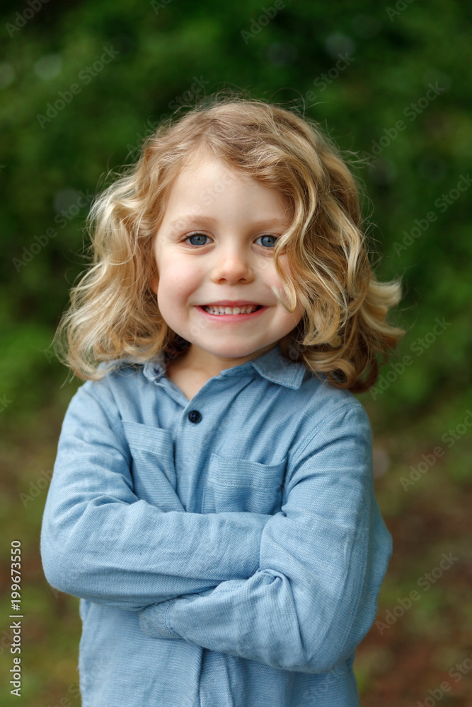 Happy child with long blond hair enjoying the nature Happy child with long blond hair enjoying the nature