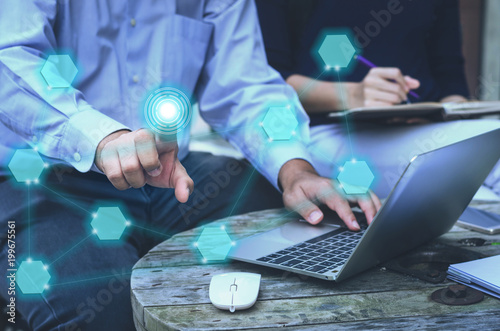 Fényképezés attractive business man working typing on laptop keyboard and using finger pressing or touching on blank modern button network technology connection on world wind web concept