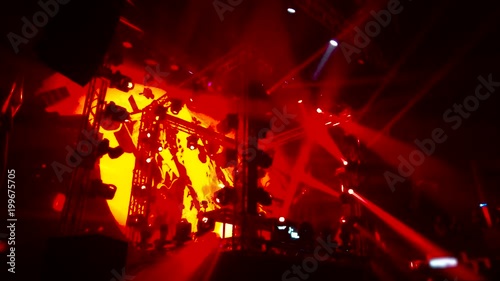 A scene with a light show of many red rotating lights