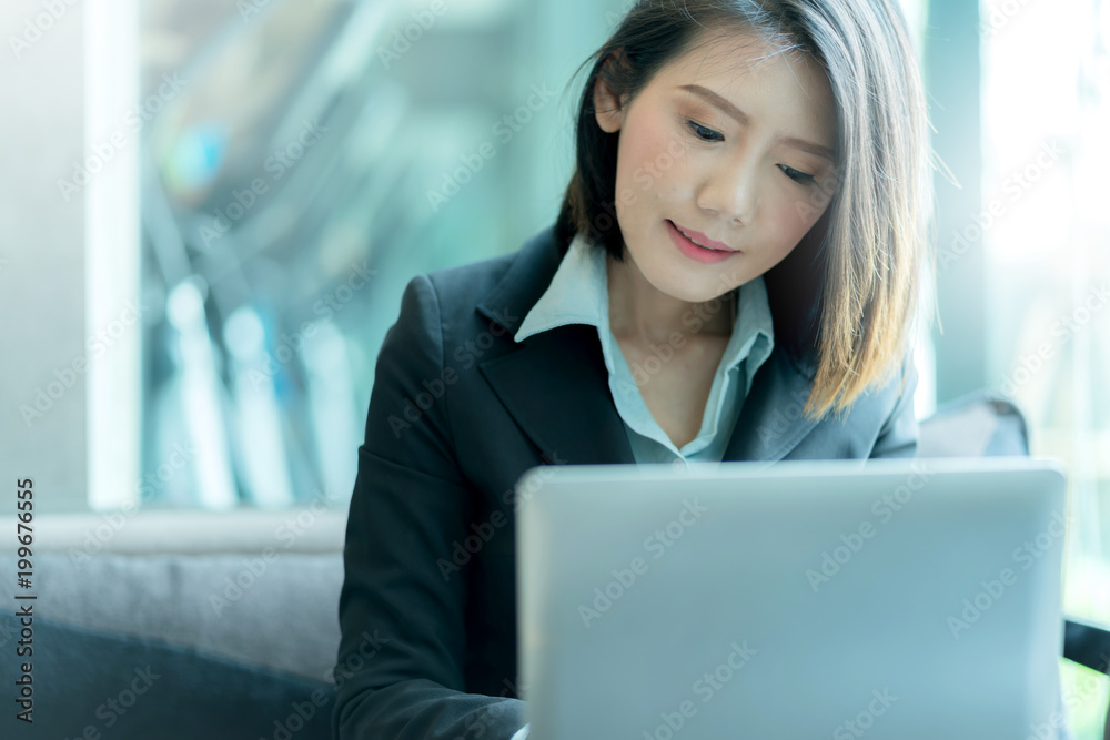 smart and beautiful business asian woman in suit contact business partner with smartphone and laptop with energy and smile smart and beautiful business asian woman in suit contact business partner with smartphone and laptop with energy and smile