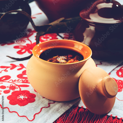 Traditional Belarusian and Ukrainian Cuisine. Potato babka, baked cake made of potato, meat and onion on the food pot. Top view, flat lay, toned image photo