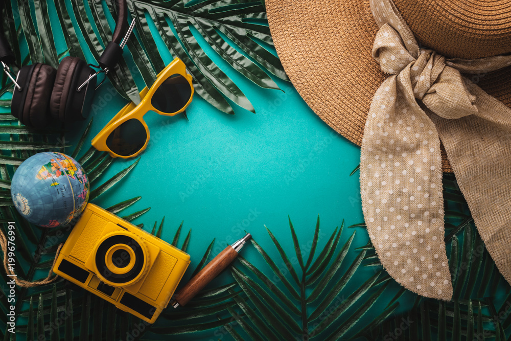 Fototapeta premium summer concept with travel stuff camera notebook glasses and woman hat flatlay image on color background with free copy space