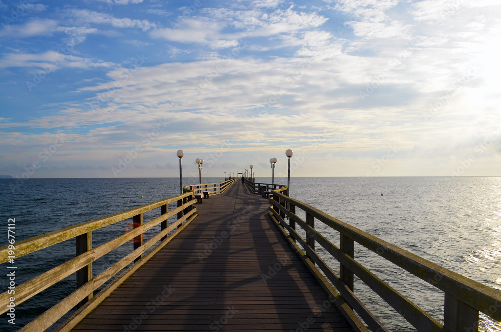 Wooden footbridge at beach from Binz, Ruegen, with view to the Baltic Sea in the rising sun