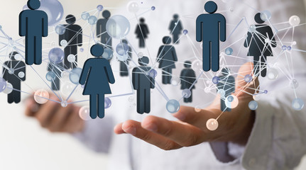 network -  Businessman holding 3D rendering group of blue people 