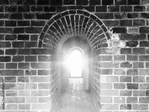 Ancient arches in China. Black and white color in high contrast with flare light. Use as background, backdrop, or montage in vintage style, or visual content for historical and architectural topics.
