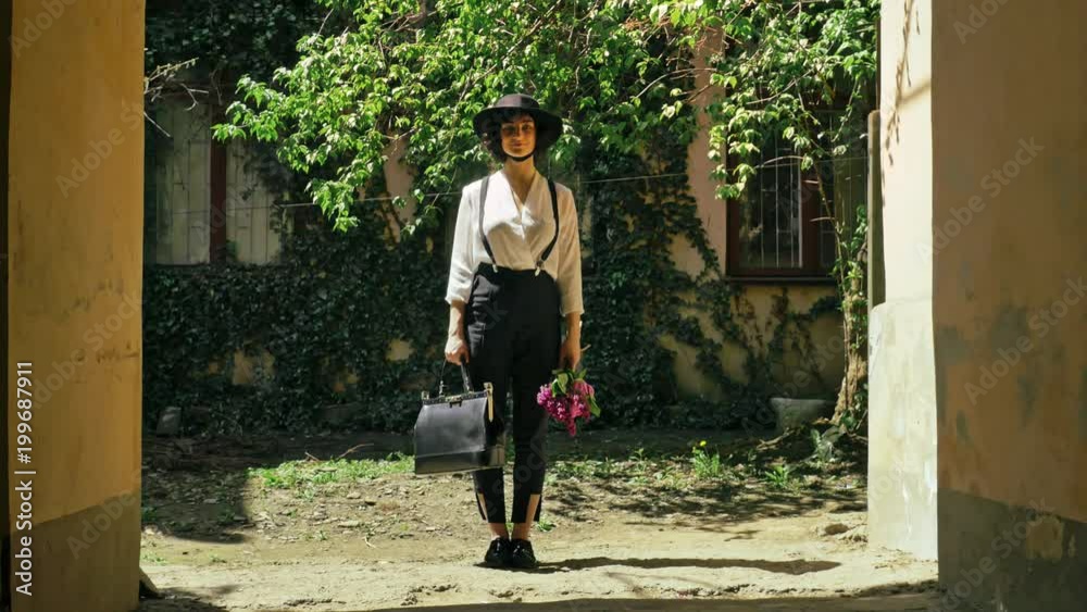 Cinemagraph - A girl under the arch leaves the bag looks around and go Cinemagraph - A girl under the arch leaves the bag looks around and go