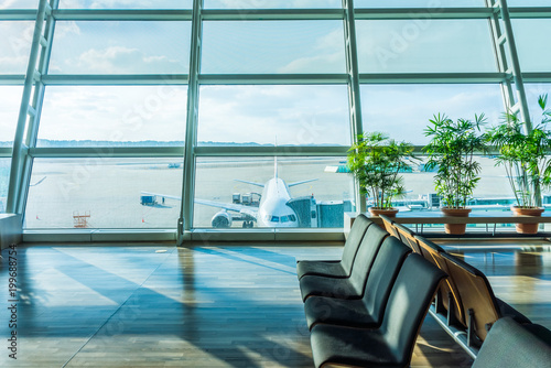 Waiting area of concourse in airport. Near parking position of an airplane.
