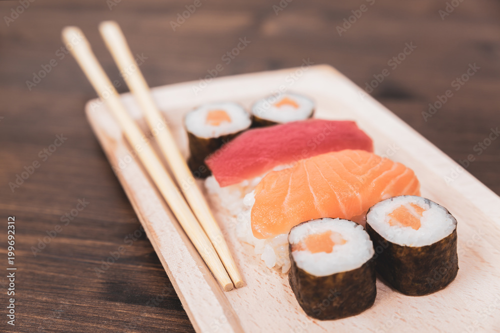 Sushi, a typical Japanese food prepared with a base of rice and various raw fish such as tuna, salmon, shrimp and sea bream. To which is added, according to the variants, the nori algae and avocados Sushi, a typical Japanese food prepared with a base of rice and various raw fish such as tuna, salmon, shrimp and sea bream. To which is added, according to the variants, the nori algae and avocados