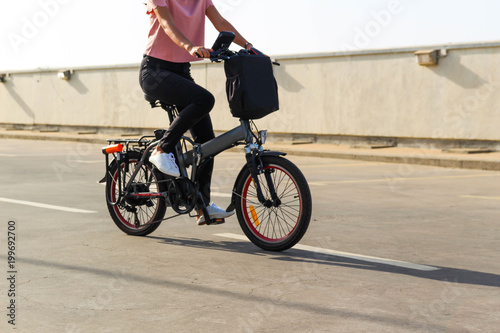 A young woman riding an electric bicycle