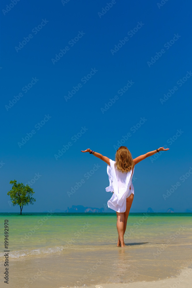 Woman relaxing on the beach in Krabi Thailand Woman relaxing on the beach in Krabi Thailand