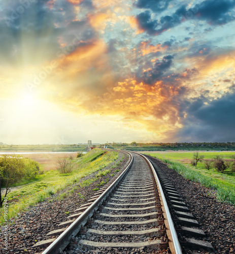 railroad to horizon in colored sunset