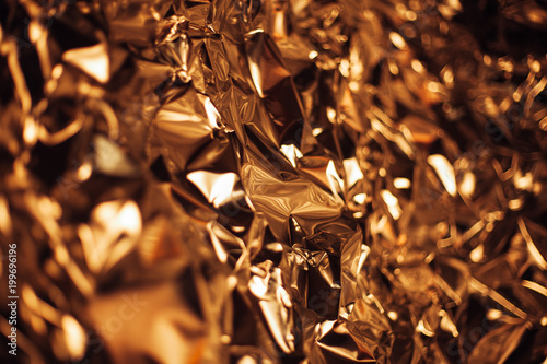 Full frame take of a sheeT of crumpled gold aluminum foil