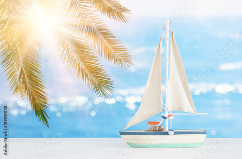 nautical concept with white decorative boat over tropical sea landscape background.
