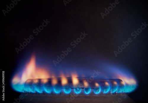 orange tongues of blue flame of a gas burner