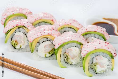 Delicious Philadelphia sushi rolls with rice, avocado, cream cheese and salmon on light background