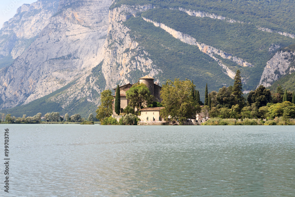 Castle Castel Toblino at lake Lago di Toblino and mountain panorama in Italy
