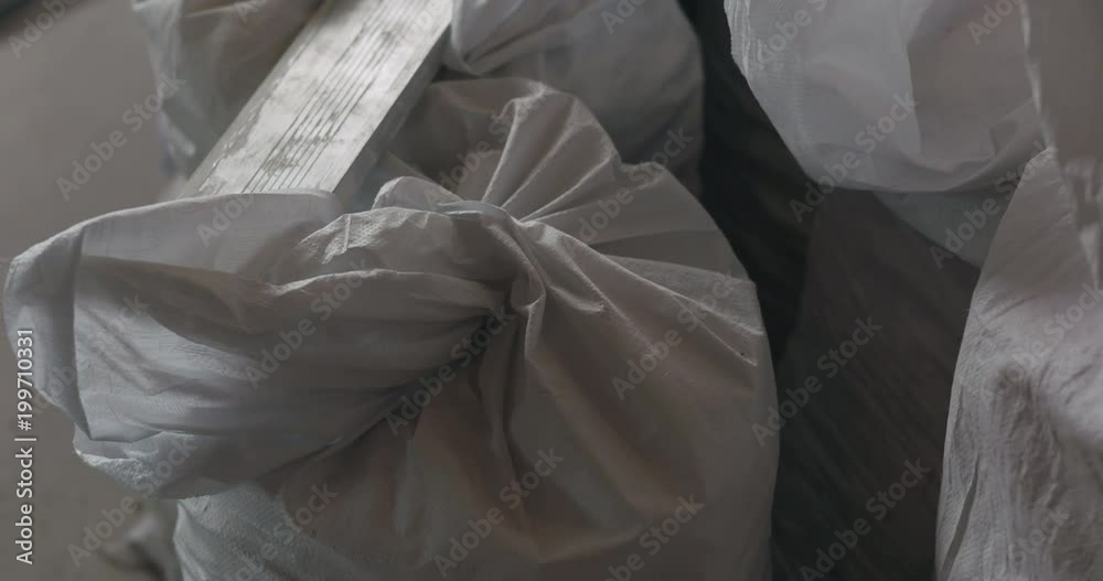 Slow motion handheld shot of construction garbage in bags Slow motion handheld shot of construction garbage in bags