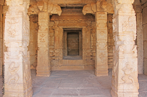 Decorative pillars from granite in mandappa or Hall. Hazara Rama Temple Hampi, Karnataka. Stone carving ancient. Indian God bas-relief. Carved columns with a pattern of stone photo