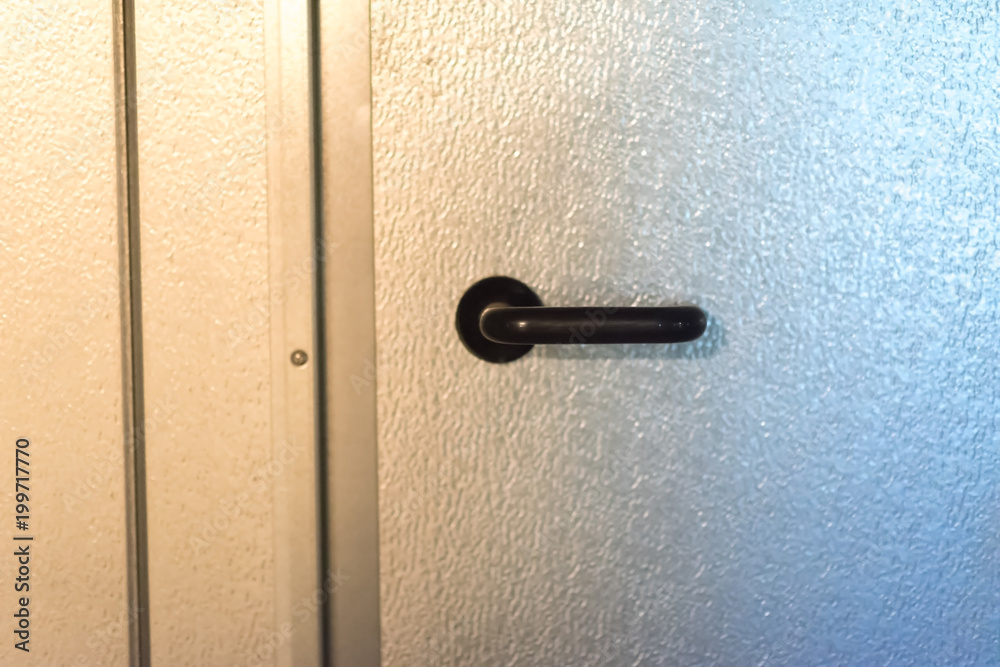 metal black handle on a silver door metal black handle on a silver door