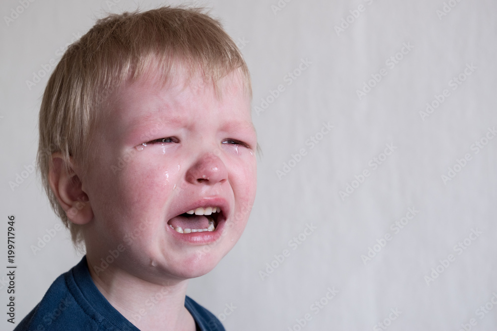 Cry. Portrait of boy. Caucasian child looks at camera. Charming boy the kid cries with tears in his eyes. an angry temper. hysterics. Cry. Portrait of boy. Caucasian child looks at camera. Charming boy the kid cries with tears in his eyes. an angry temper. hysterics.