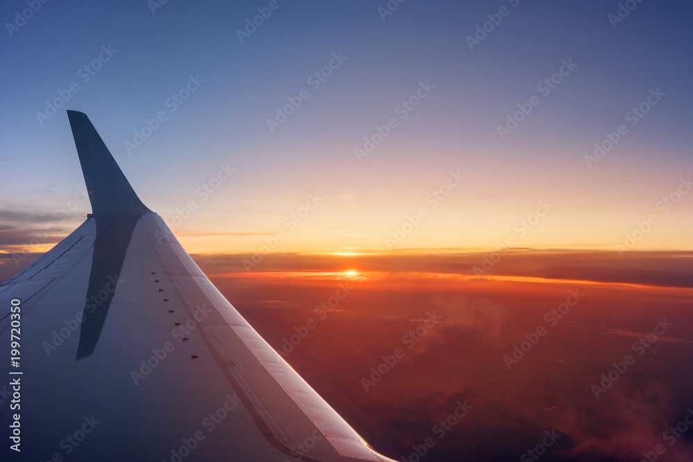 Airplane wing during a vibrant sunset