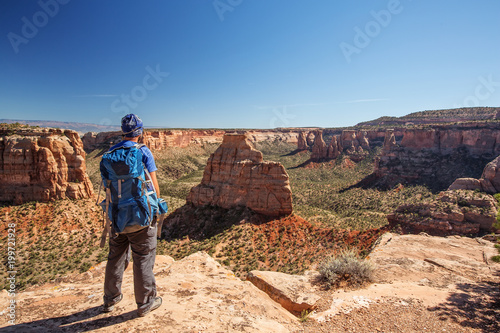 Hiker is sitting on the cliff in Colorado National monument, USA