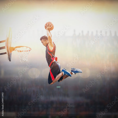 Obraz na plátne Basketball Player scoring an athletic, action slam dunk