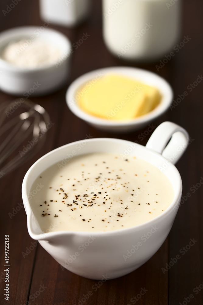 Homemade French Bechamel or White Sauce, ingredients in the back (flour, butter, milk), photographed with natural light (Selective Focus, Focus one third into the image) Homemade French Bechamel or White Sauce, ingredients in the back (flour, butter, milk), photographed with natural light (Selective Focus, Focus one third into the image)