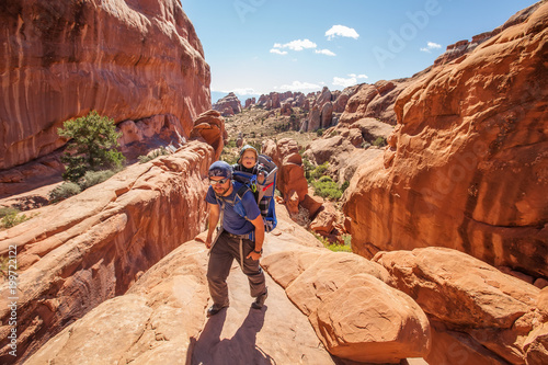 A family with baby son visits Arches National Park in Utah, USA