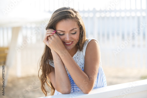 Portrait of Young stylish beautiful woman in blue printed dress on the beach Free Download Portrait of Young stylish beautiful woman in blue printed dress on the beach - GFXLoad
