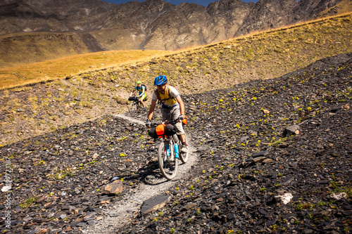 Mountain bikers are travelling in the highlands of Tusheti region, Georgia